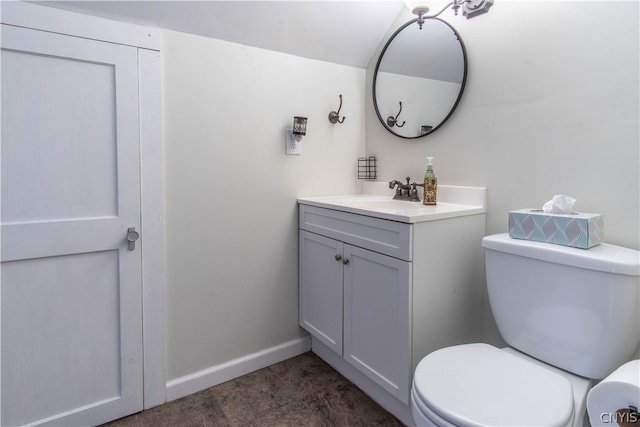 bathroom featuring tile patterned floors, toilet, and vanity