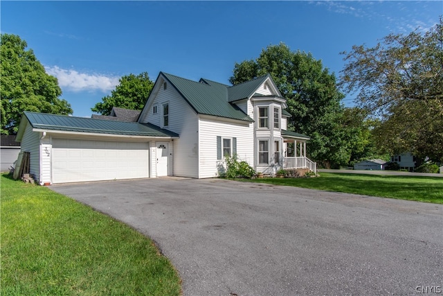 view of front of home with a garage and a front yard