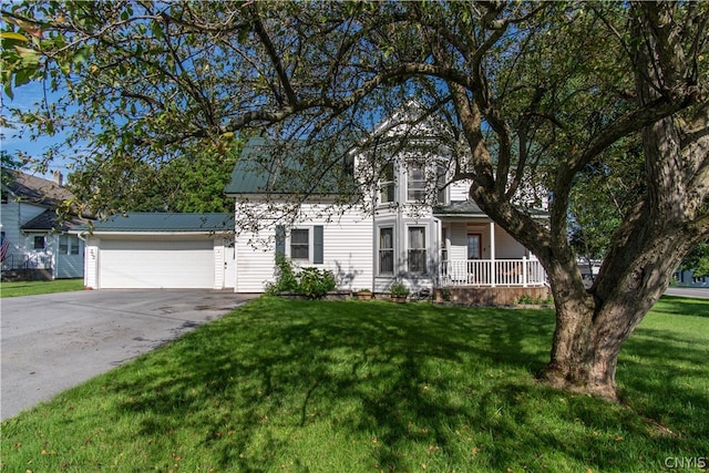 view of front of property with a garage and a front lawn