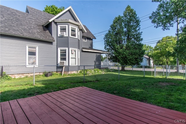 wooden terrace featuring a lawn