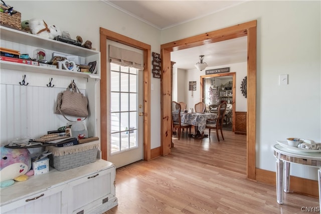 mudroom with light hardwood / wood-style floors, crown molding, and plenty of natural light