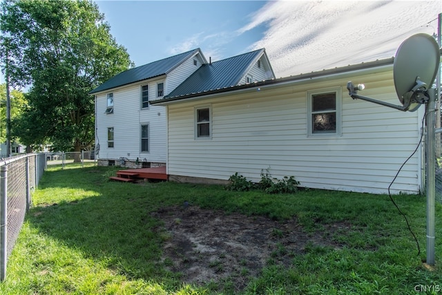 rear view of house featuring a yard