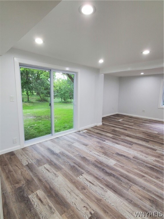 empty room with hardwood / wood-style floors