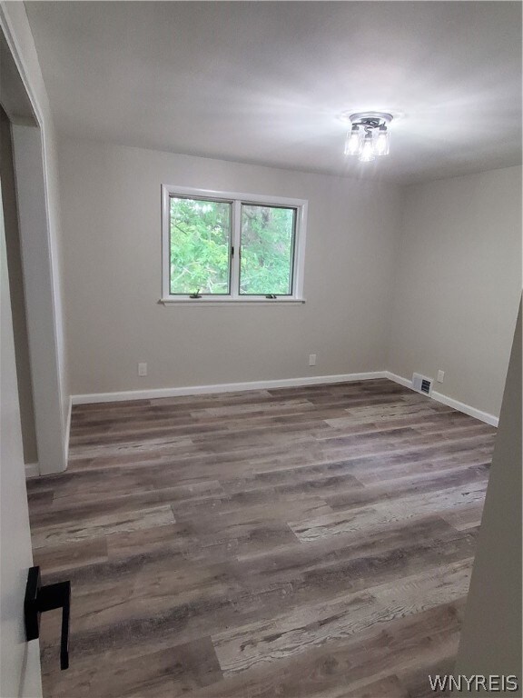 empty room featuring hardwood / wood-style flooring