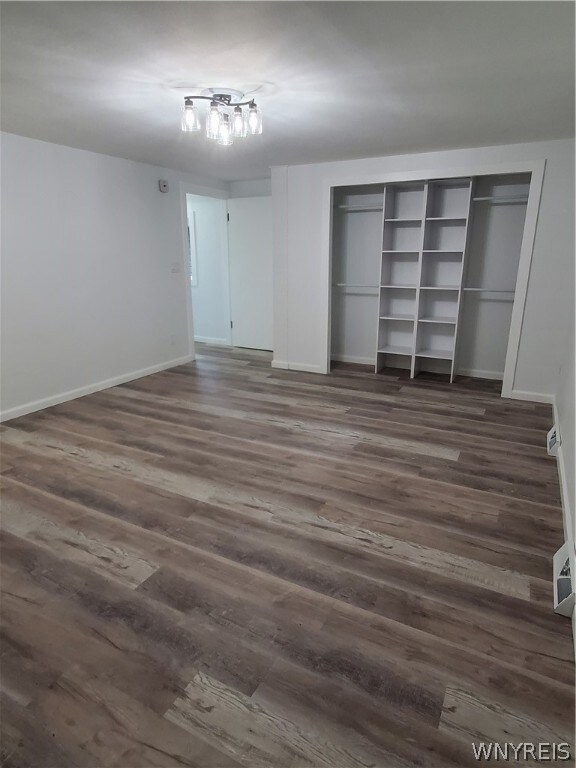 unfurnished bedroom with a closet and wood-type flooring