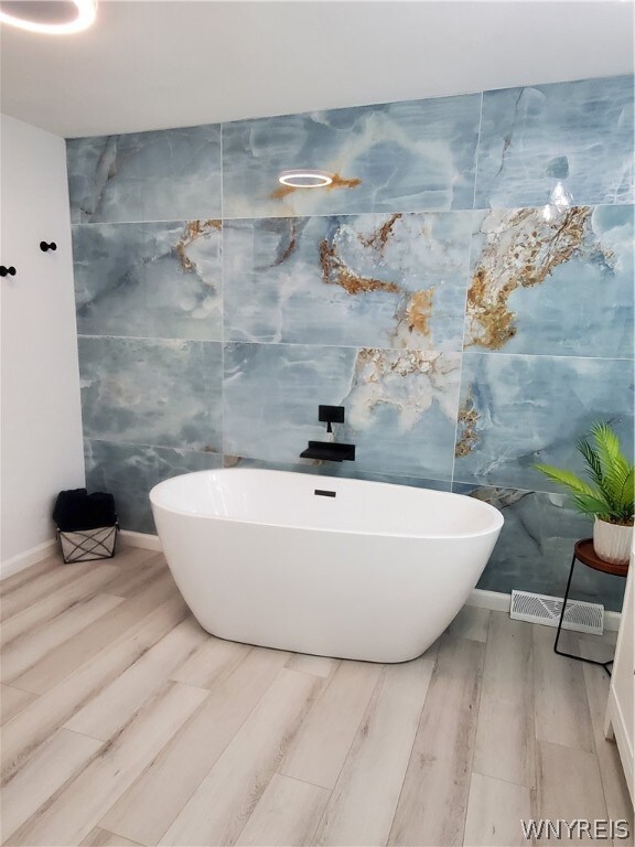 bathroom featuring tile walls and wood-type flooring