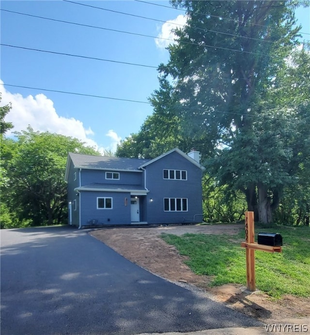 front facade with a front yard