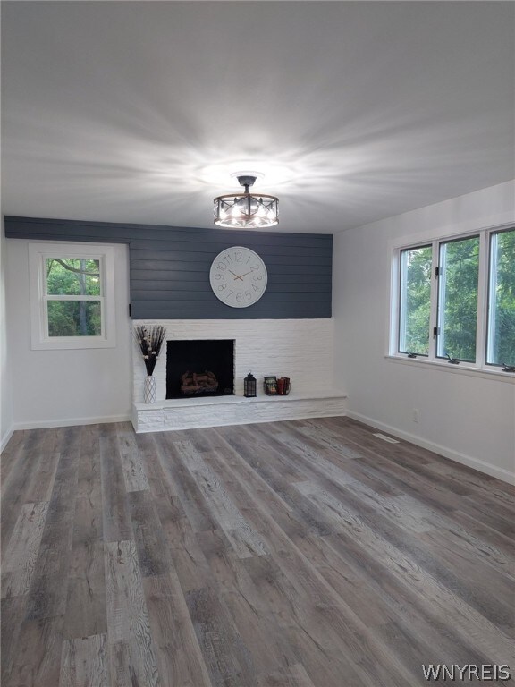 unfurnished living room with a fireplace and hardwood / wood-style floors