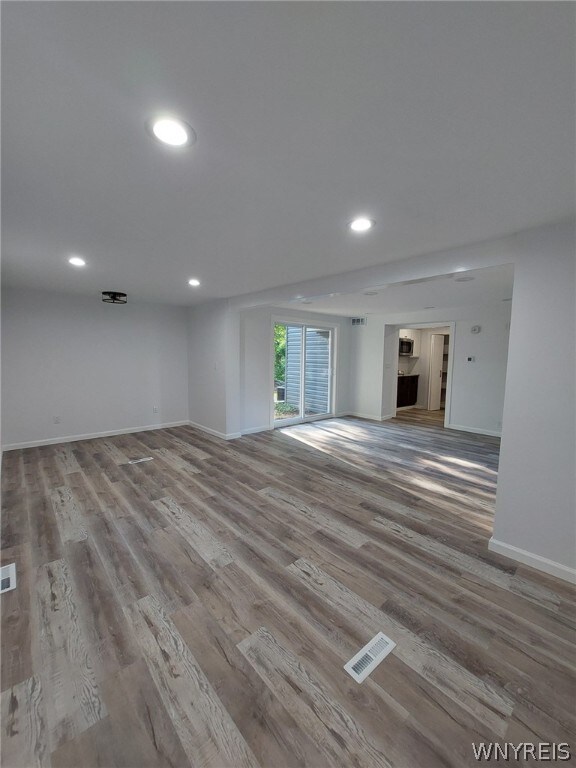 unfurnished living room featuring hardwood / wood-style floors