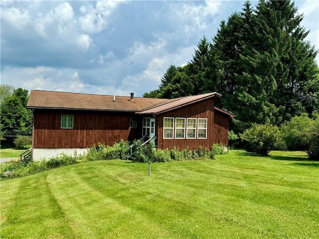 rear view of house with a lawn