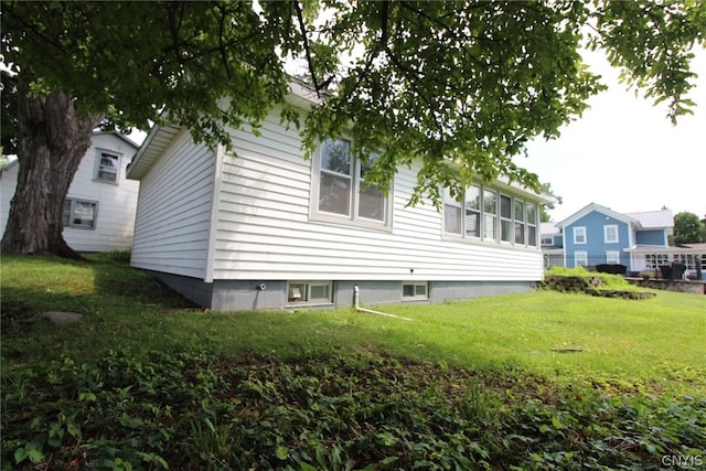 view of side of home featuring a lawn