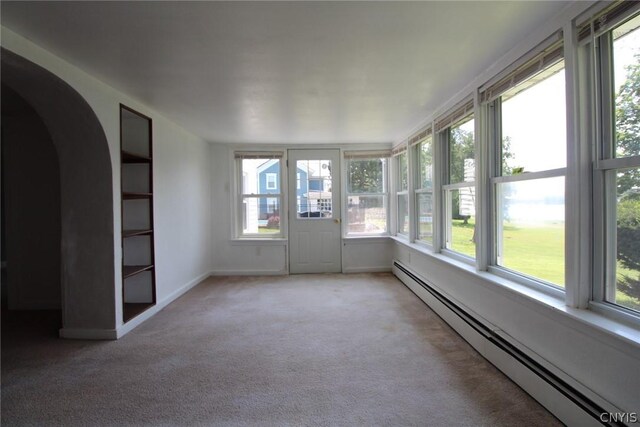 850 County Route 37, Hastings, NY 13036 - unfurnished sunroom with baseboard heating, healthy amount of natural light, carpet flooring, and arched walkways
