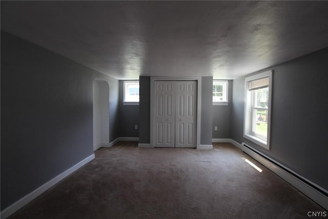 850 County Route 37, Hastings, NY 13036 - unfurnished bedroom featuring baseboard heating, carpet flooring, arched walkways, and baseboards