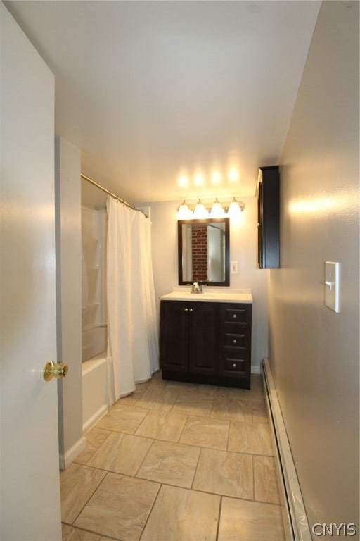 bathroom featuring vanity, baseboard heating, and shower / tub combo