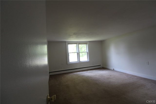 carpeted empty room with a baseboard radiator