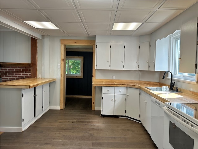 kitchen with wood counters, white cabinets, dishwasher, sink, and dark wood-type flooring