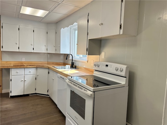 kitchen with sink, dark wood-type flooring, white appliances, and white cabinets