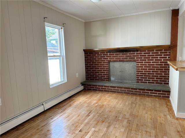 unfurnished living room featuring a fireplace, light hardwood / wood-style flooring, ornamental molding, and baseboard heating