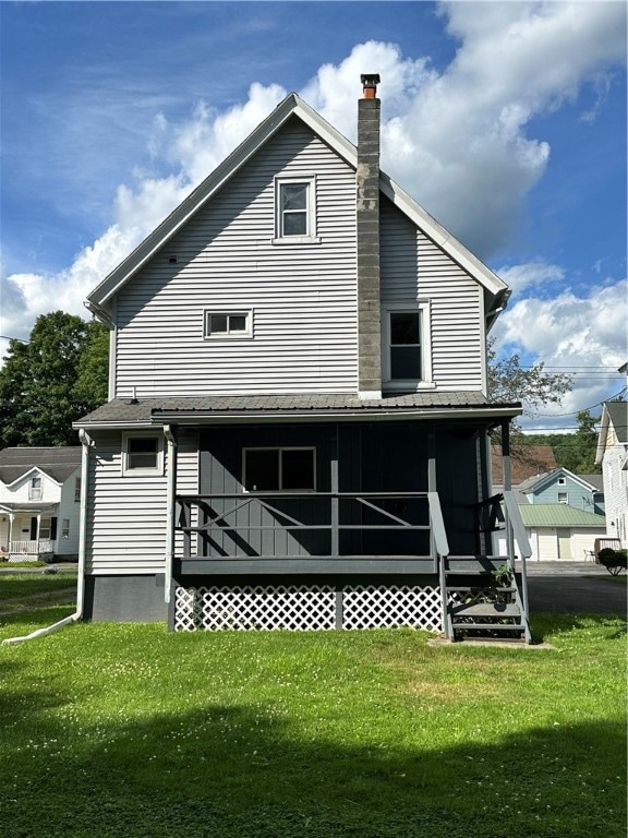 back of property featuring a lawn