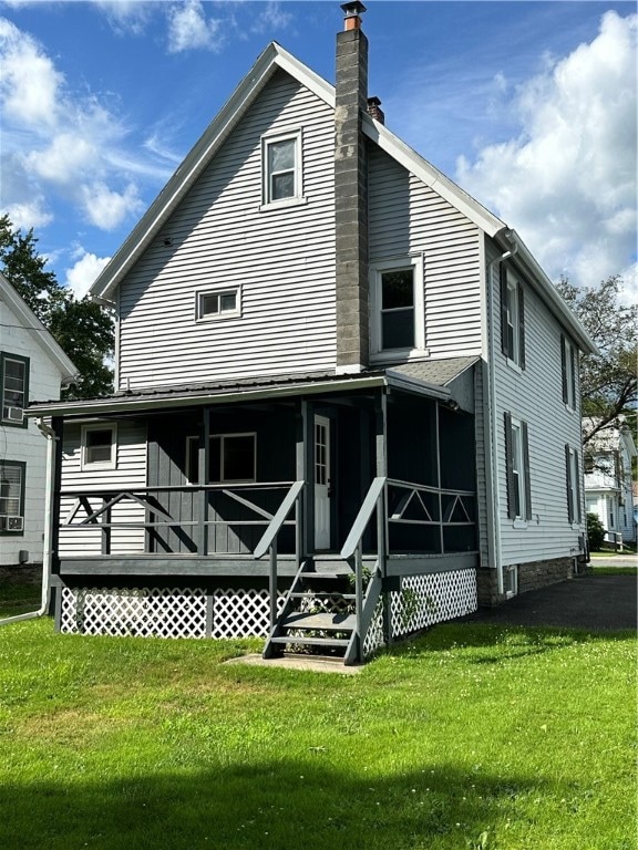 back of property featuring a lawn