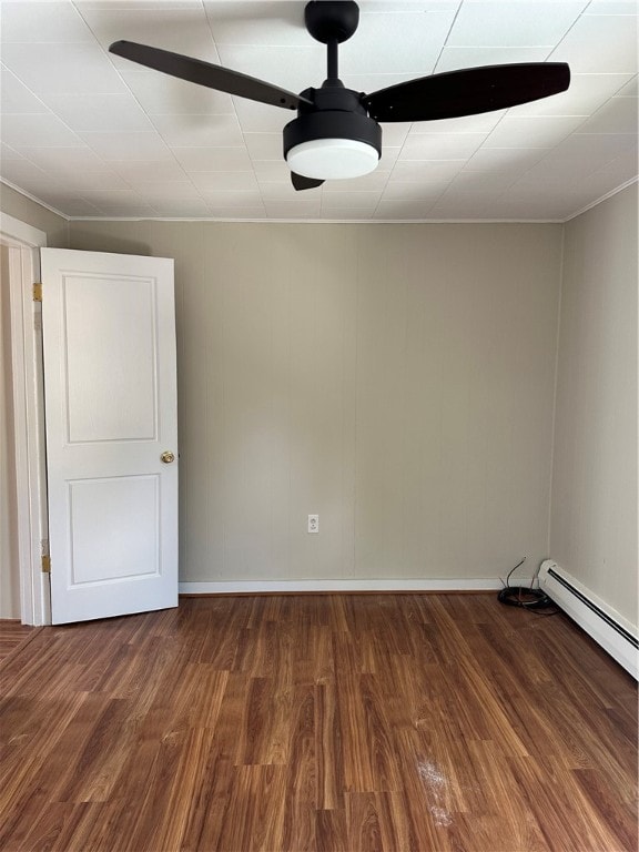 spare room with hardwood / wood-style flooring and a baseboard heating unit