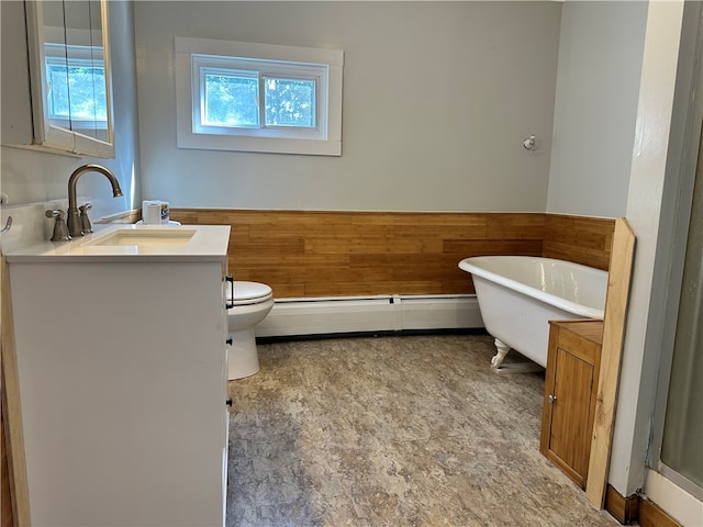 bathroom featuring vanity, a bathtub, toilet, baseboard heating, and tile patterned flooring