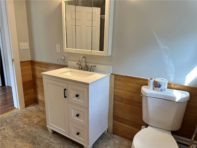 bathroom with vanity, a baseboard heating unit, and toilet