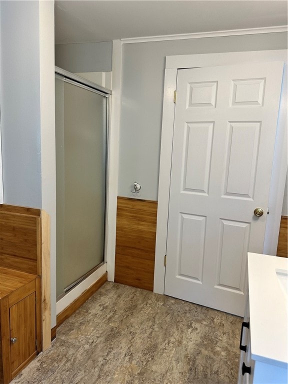 bathroom featuring walk in shower, tile patterned flooring, and vanity