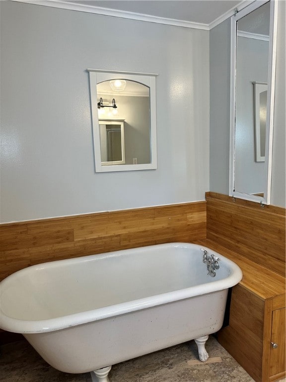 bathroom featuring crown molding and a tub