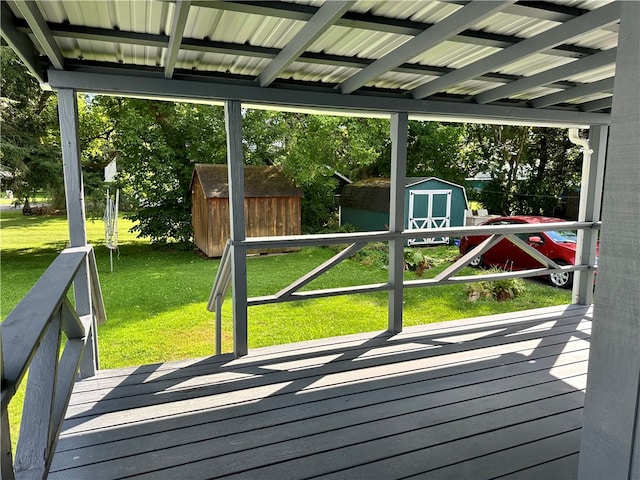 deck with a yard and a storage shed