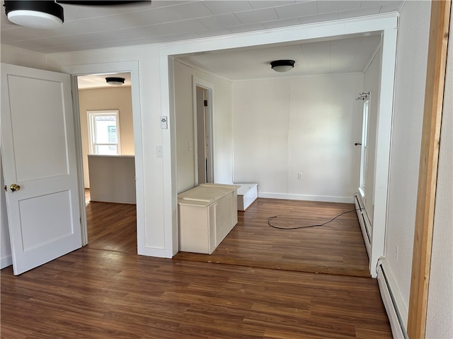 corridor featuring hardwood / wood-style flooring and a baseboard heating unit