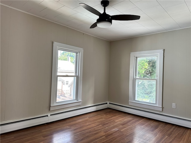 unfurnished room featuring ceiling fan, wood-type flooring, and baseboard heating