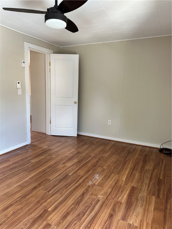 empty room with hardwood / wood-style flooring and ceiling fan