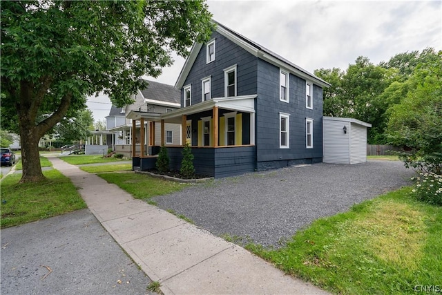 view of property exterior with a porch and a lawn