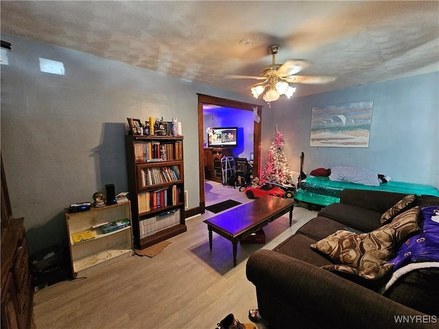 living room featuring ceiling fan and light hardwood / wood-style floors