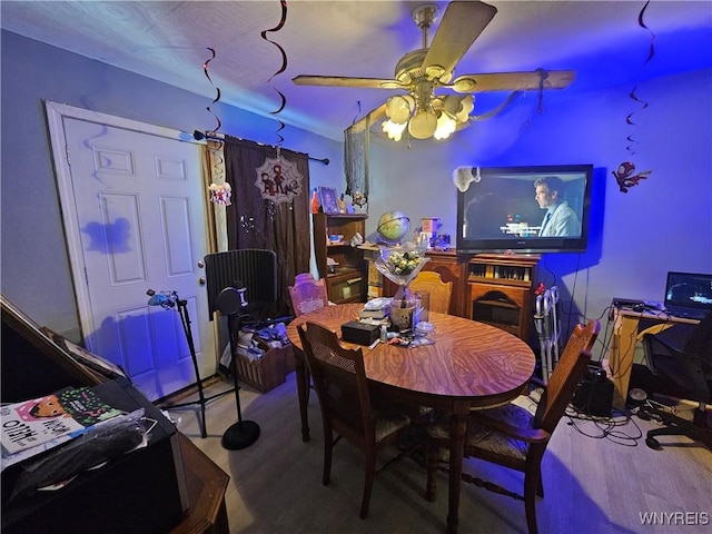 dining space with wood finished floors and ceiling fan