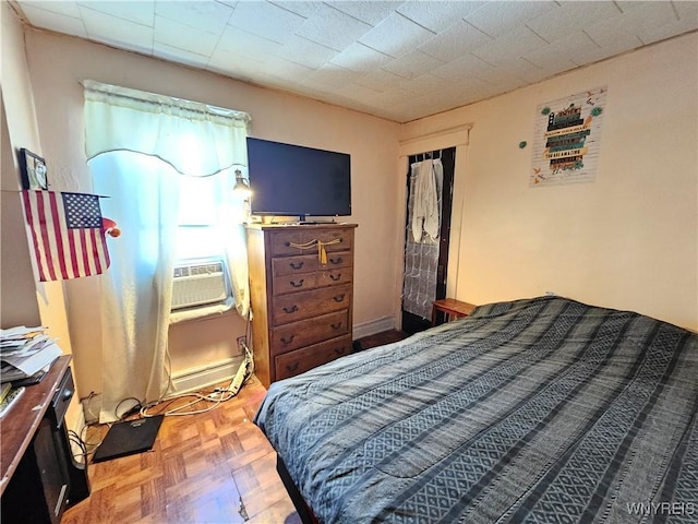 bedroom with cooling unit and baseboard heating