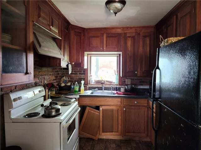 kitchen with black fridge, electric stove, and sink
