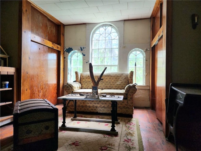 living area with a wealth of natural light and wood-type flooring
