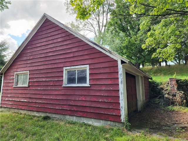 view of side of property with an outbuilding and a garage