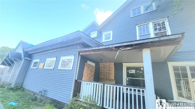 view of side of home with a porch