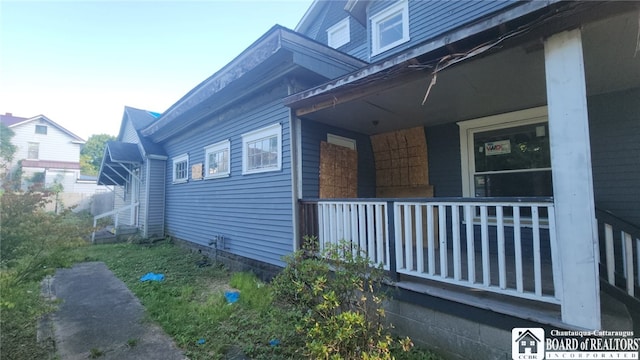 view of property exterior with covered porch