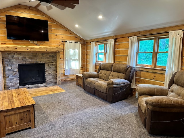 living room with ceiling fan, a stone fireplace, wooden walls, and a wealth of natural light