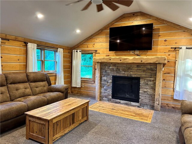 carpeted living room with wooden walls, ceiling fan, and vaulted ceiling