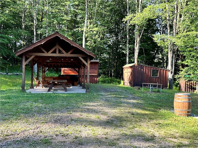 view of yard featuring a gazebo and an outbuilding