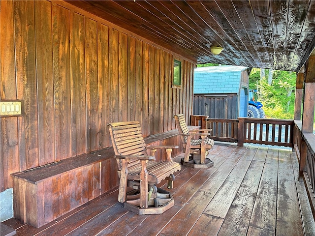 wooden terrace with a shed