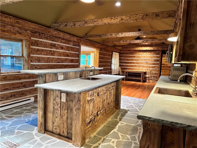 kitchen with log walls, sink, beamed ceiling, and hardwood / wood-style floors