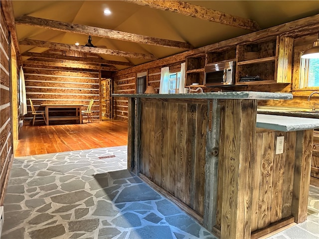 interior space featuring vaulted ceiling with beams and hardwood / wood-style floors