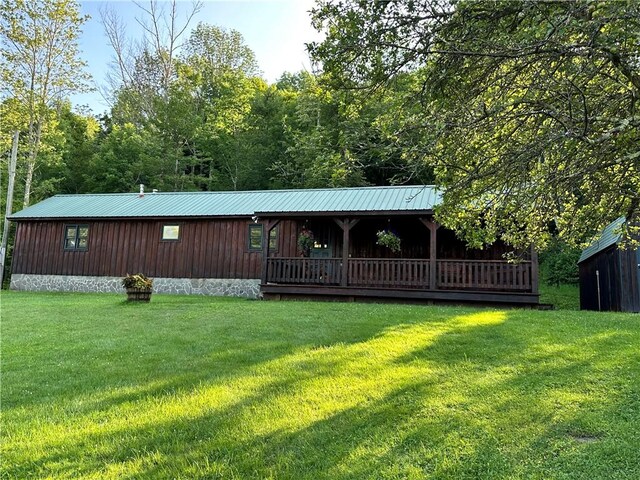 rear view of house featuring a yard