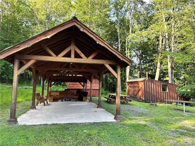 view of community with a patio, a lawn, an outbuilding, and a gazebo